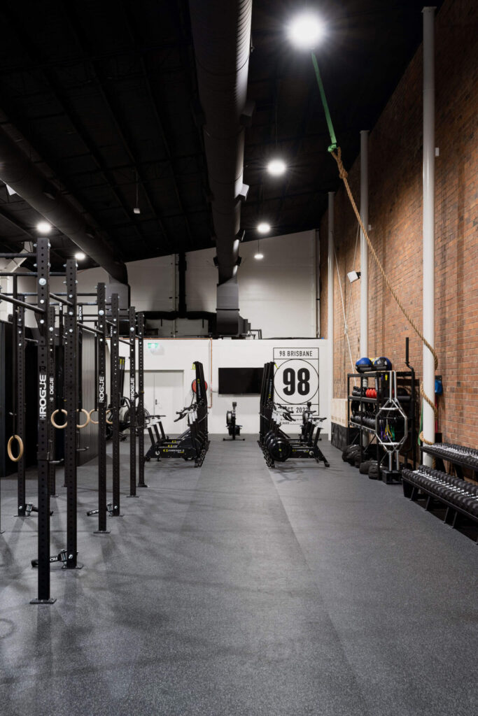 Industrial brick walls and styling, black functional equipment and ample lighting for this fitness fit out for 98 Gym