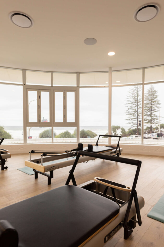 Light colour palette, high end reformer beds and custom LED signage for this fitness fit out for FS8
