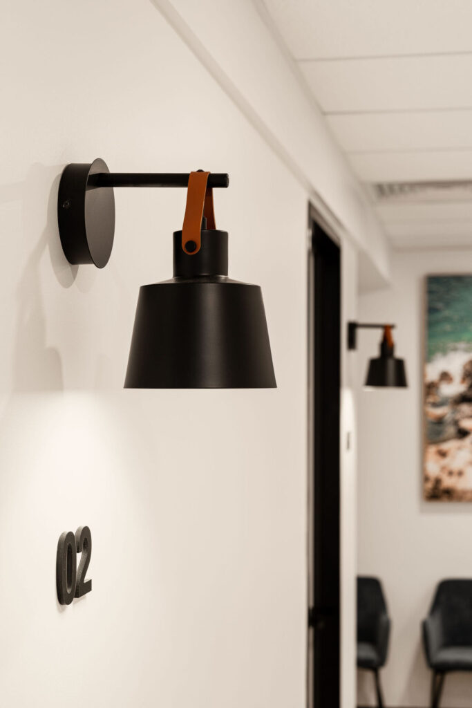 Black and white optometry equipment, a coastal-inspired aesthetic and sleek black wall lights for this medical fit out for Insight Eye Surgery, Total Fitouts Sunshine Coast South